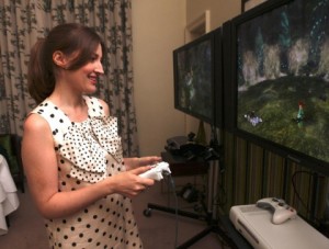 Actress Kelly Macdonald, who voices lead character Merida for Disney-Pixar's upcoming film Brave and Brave: The Video Game, plays the game at a recent event in Scotland. (Photo: Business Wire)